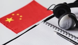 headphones notebook and Chinese flag