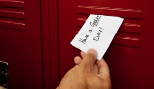 note saying have a great day being put in a locker