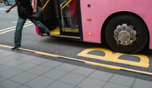 person stepping off a bus